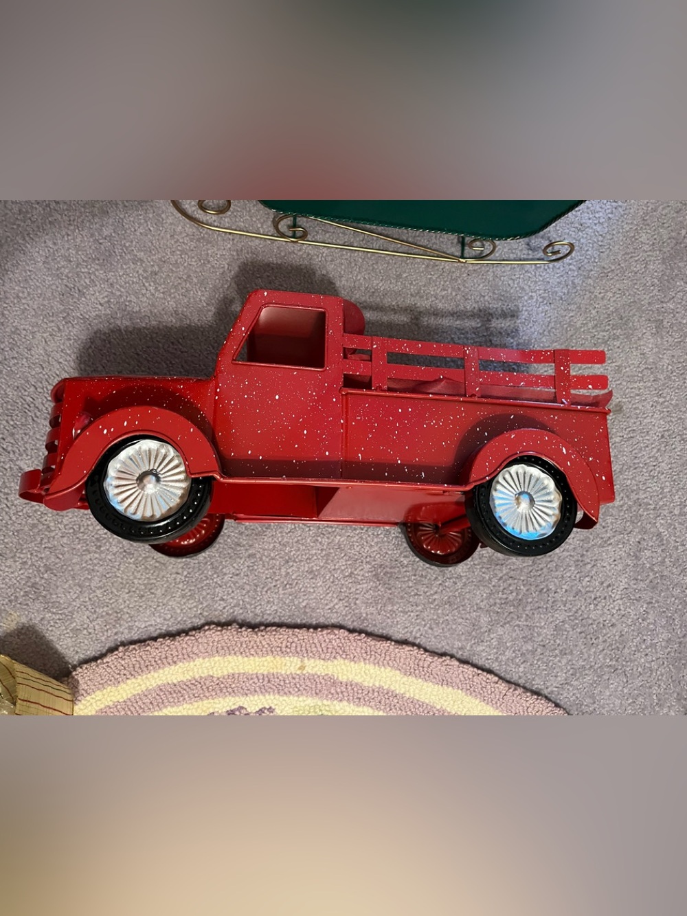 Metal holiday decor set includes a red pickup truck and a green sleigh.